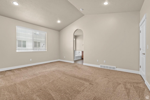 93 E 425 N, Vineyard, UT 84059 - empty room featuring baseboards, carpet floors, visible vents, lofted ceiling, and arched walkways