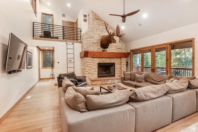 3009 E Black Forest Rd, Sundance, UT 84604 - living room featuring high vaulted ceiling, a fireplace, ceiling fan, light hardwood / wood-style floors, and french doors