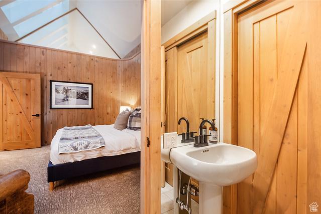 3009 E Black Forest Rd, Sundance, UT 84604 - bedroom featuring sink, carpet floors, wooden walls, and vaulted ceiling