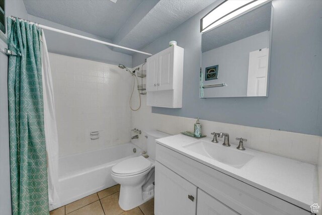333 E 4500 S Unit 12, Murray, UT 84107 - full bathroom featuring tile patterned flooring, vanity, toilet, a textured ceiling, and shower / bath combo with shower curtain