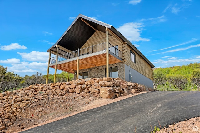 999 Cisco Run, Garden City, UT 84028 - view of property exterior with stone siding, a deck, and log siding