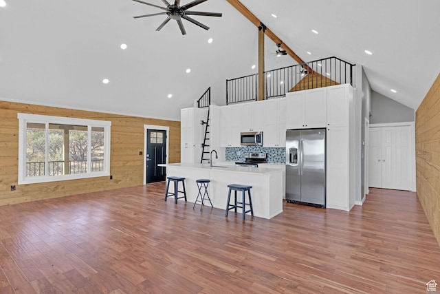 999 Cisco Run, Garden City, UT 84028 - kitchen with appliances with stainless steel finishes, ceiling fan, open floor plan, a sink, and high vaulted ceiling