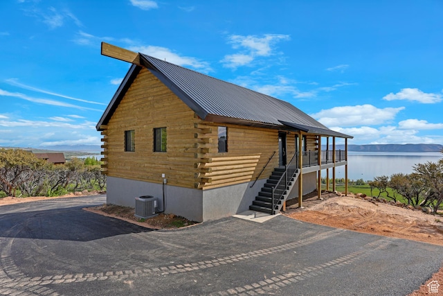 999 Cisco Run, Garden City, UT 84028 - view of property exterior featuring log exterior, a water view, central air condition unit, stairway, and metal roof