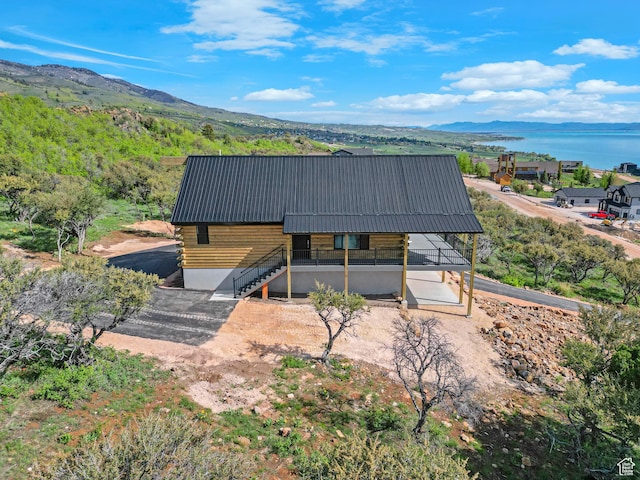 999 Cisco Run, Garden City, UT 84028 - view of front of house featuring metal roof, a water and mountain view, stairway, and log siding