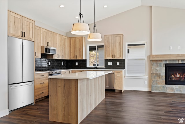 4778 Paddleford Dr Unit 227, Eden, UT 84310 - kitchen with appliances with stainless steel finishes, light brown cabinetry, vaulted ceiling, a kitchen island, and dark wood-type flooring
