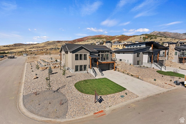 4778 Paddleford Dr Unit 227, Eden, UT 84310 - view of front of home with board and batten siding, a mountain view, driveway, an attached garage, and a residential view