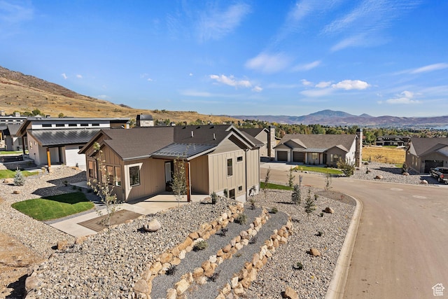 4778 Paddleford Dr Unit 227, Eden, UT 84310 - view of front of property featuring board and batten siding, a mountain view, a residential view, and a patio area
