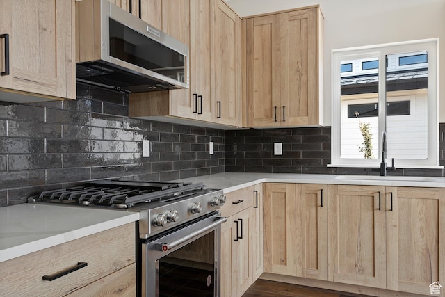 4778 Paddleford Dr Unit 227, Eden, UT 84310 - kitchen featuring light brown cabinetry, appliances with stainless steel finishes, a sink, decorative backsplash, and light countertops