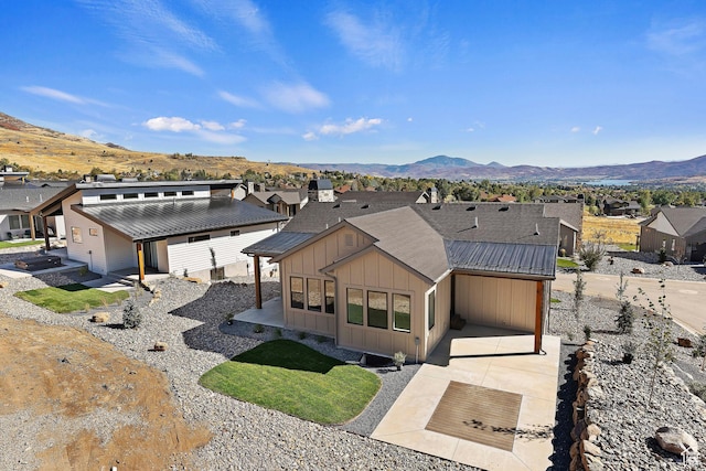 4778 Paddleford Dr Unit 227, Eden, UT 84310 - view of front of property featuring board and batten siding, a mountain view, a residential view, an attached carport, and driveway