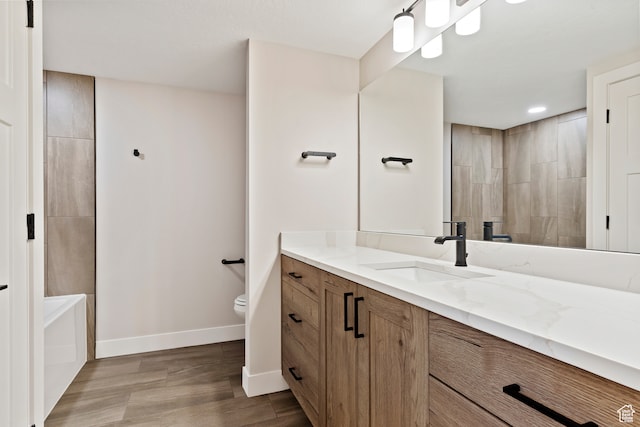 4778 Paddleford Dr Unit 227, Eden, UT 84310 - full bath with baseboards, toilet, vanity, wood finished floors, and a tub