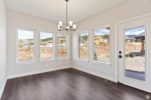 4778 Paddleford Dr Unit 227, Eden, UT 84310 - unfurnished dining area with dark wood finished floors, a chandelier, and baseboards