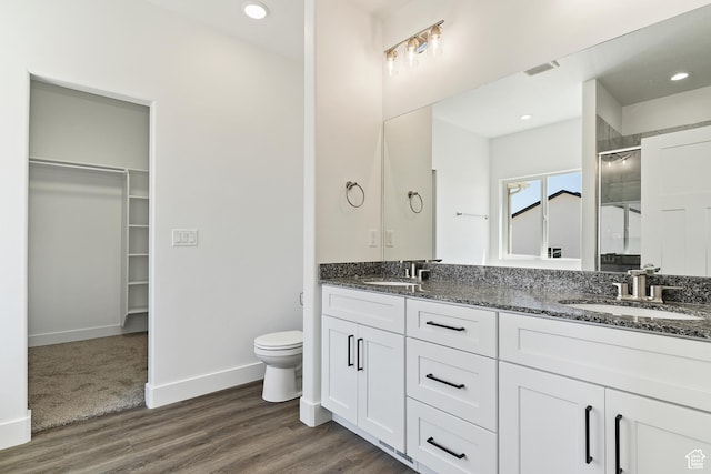 bathroom with a sink, visible vents, toilet, and a shower stall