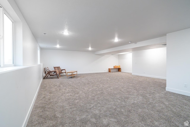 unfurnished room featuring visible vents, baseboards, and carpet flooring