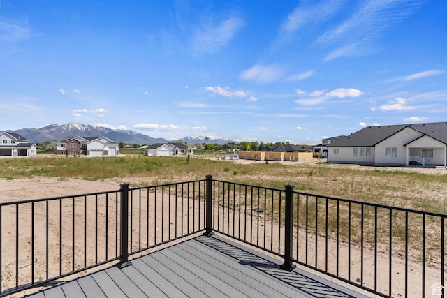 wooden terrace with a mountain view and a residential view