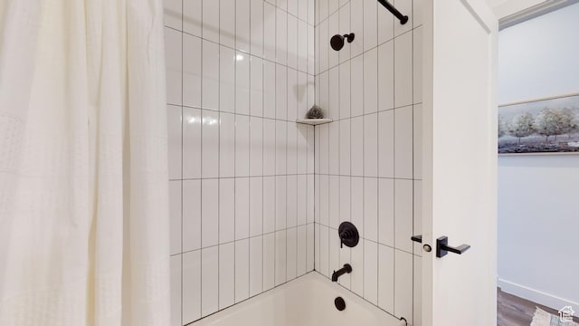 bathroom featuring shower / bath combo with shower curtain and hardwood / wood-style flooring