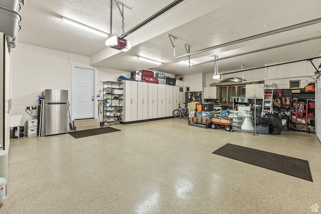 14234 S Canyon Vine Cv E, Draper, UT 84020 - garage with stainless steel refrigerator and a garage door opener