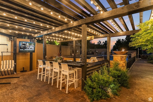 14234 S Canyon Vine Cv E, Draper, UT 84020 - patio terrace at dusk featuring a pergola, an outdoor bar, and an outdoor kitchen