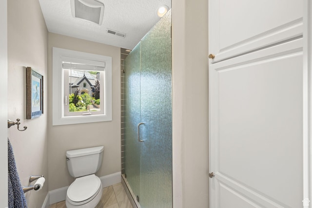 14234 S Canyon Vine Cv E, Draper, UT 84020 - bathroom featuring tile patterned flooring, a shower with shower door, a textured ceiling, and toilet