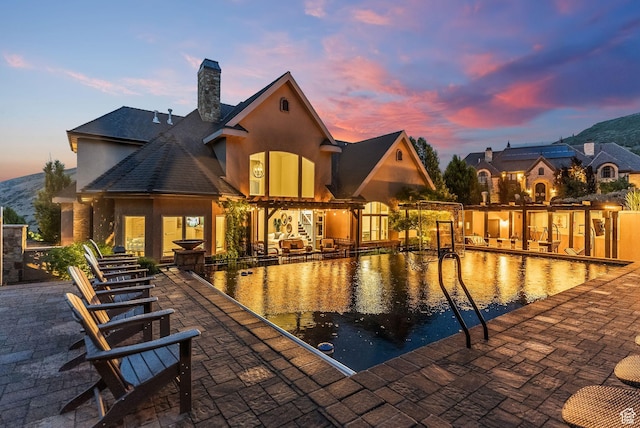 14234 S Canyon Vine Cv E, Draper, UT 84020 - pool at dusk with a patio area