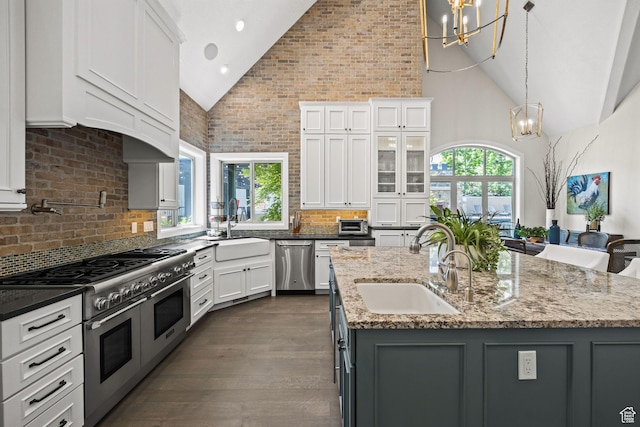 14234 S Canyon Vine Cv E, Draper, UT 84020 - kitchen with white cabinetry, an island with sink, stainless steel appliances, and high vaulted ceiling