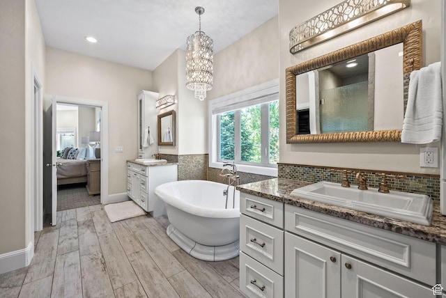 14234 S Canyon Vine Cv E, Draper, UT 84020 - bathroom with vanity, independent shower and bath, and an inviting chandelier