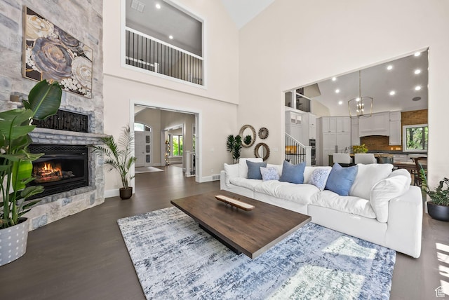 14234 S Canyon Vine Cv E, Draper, UT 84020 - living room with dark hardwood / wood-style flooring, a fireplace, high vaulted ceiling, and an inviting chandelier