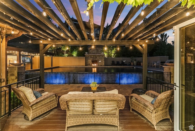 14234 S Canyon Vine Cv E, Draper, UT 84020 - pool at dusk featuring a pergola, a wooden deck, and an outdoor living space with a fireplace