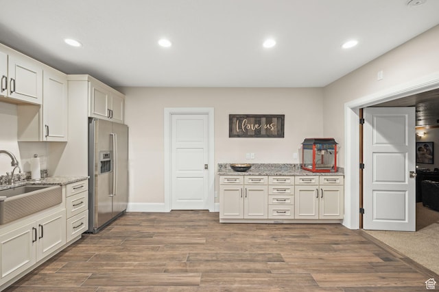 14234 S Canyon Vine Cv E, Draper, UT 84020 - kitchen with white cabinetry, sink, light stone countertops, dark hardwood / wood-style flooring, and stainless steel fridge