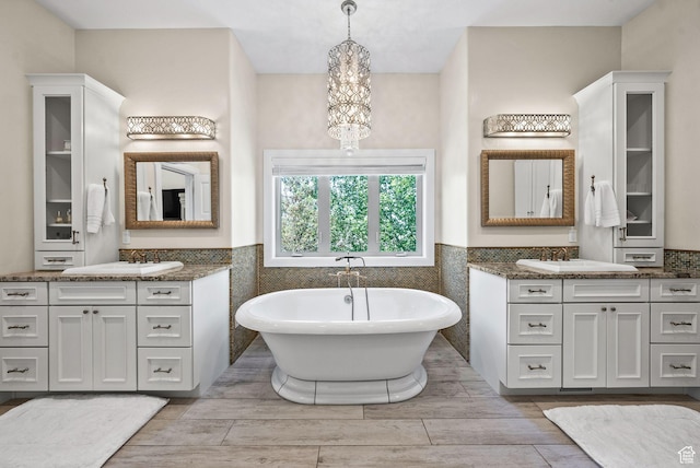 14234 S Canyon Vine Cv E, Draper, UT 84020 - bathroom featuring a washtub, tile walls, vanity, and a chandelier