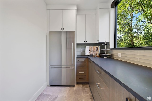 940 S N View Cir Unit 12, Woodland Hills, UT 84653 - kitchen featuring white cabinets, decorative backsplash, and stainless steel fridge