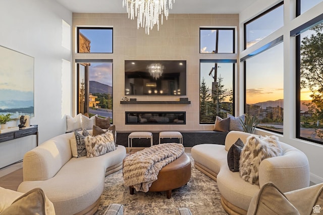 940 S N View Cir Unit 12, Woodland Hills, UT 84653 - sunroom / solarium with a tiled fireplace, a healthy amount of sunlight, and an inviting chandelier