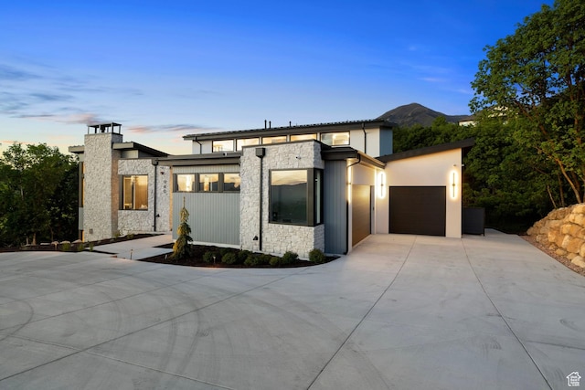 940 S N View Cir Unit 12, Woodland Hills, UT 84653 - contemporary home featuring concrete driveway, stone siding, and a garage