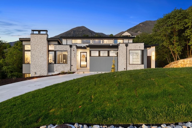 940 S N View Cir Unit 12, Woodland Hills, UT 84653 - view of front facade with a front yard, a mountain view, a chimney, and stone siding