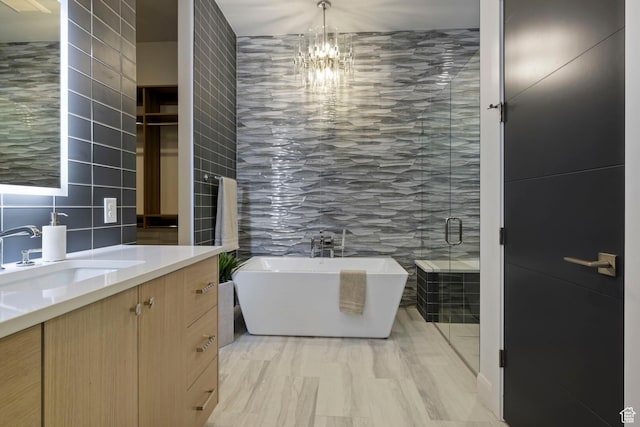 940 S N View Cir Unit 12, Woodland Hills, UT 84653 - bathroom featuring decorative backsplash, vanity, tile walls, a notable chandelier, and shower with separate bathtub