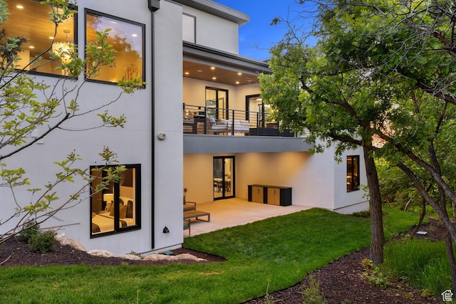 940 S N View Cir Unit 12, Woodland Hills, UT 84653 - back of property featuring a balcony, stucco siding, a patio area, and a lawn