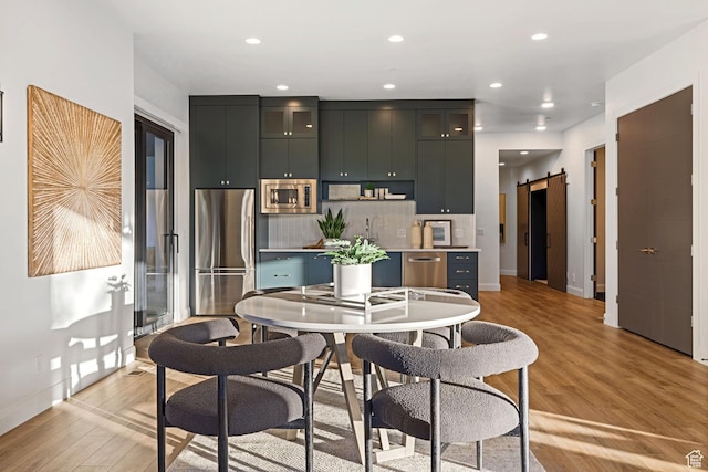 940 S N View Cir Unit 12, Woodland Hills, UT 84653 - dining area with a barn door and light hardwood / wood-style floors