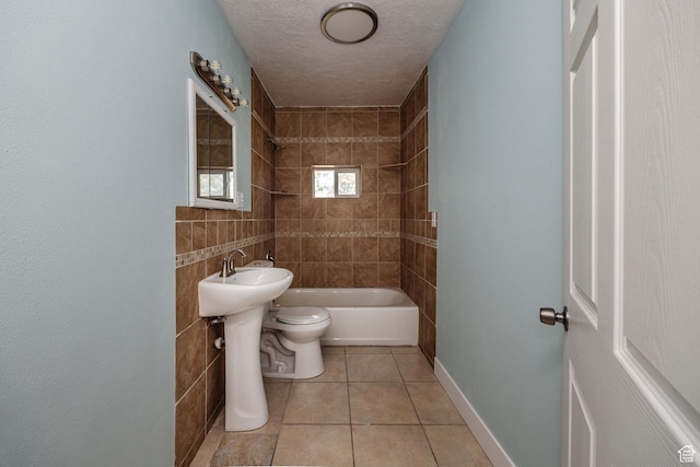 1090 S 2400 W, Lewiston, UT 84320 - bathroom with a textured ceiling, baseboards, toilet, tile patterned flooring, and shower / bathtub combination