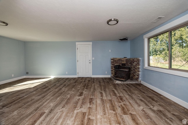 1090 S 2400 W, Lewiston, UT 84320 - unfurnished living room featuring baseboards, visible vents, wood finished floors, and a textured ceiling