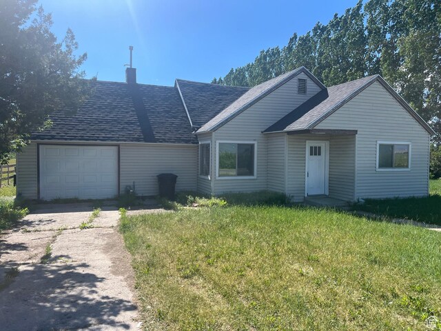 1090 S 2400 W, Lewiston, UT 84320 - single story home with an attached garage, a chimney, a front yard, roof with shingles, and driveway