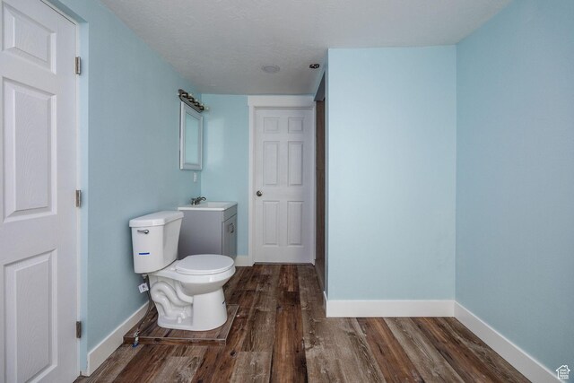 1090 S 2400 W, Lewiston, UT 84320 - bathroom with toilet, vanity, baseboards, and wood finished floors