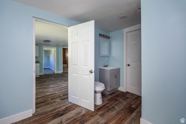 1090 S 2400 W, Lewiston, UT 84320 - bathroom with baseboards, wood finished floors, toilet, and vanity