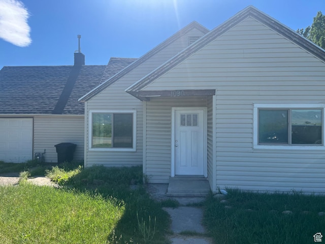 1090 S 2400 W, Lewiston, UT 84320 - view of front of property featuring an attached garage, a chimney, and a shingled roof
