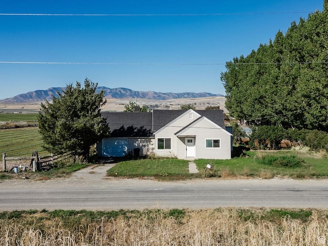view of front of home with fence and a mountain view