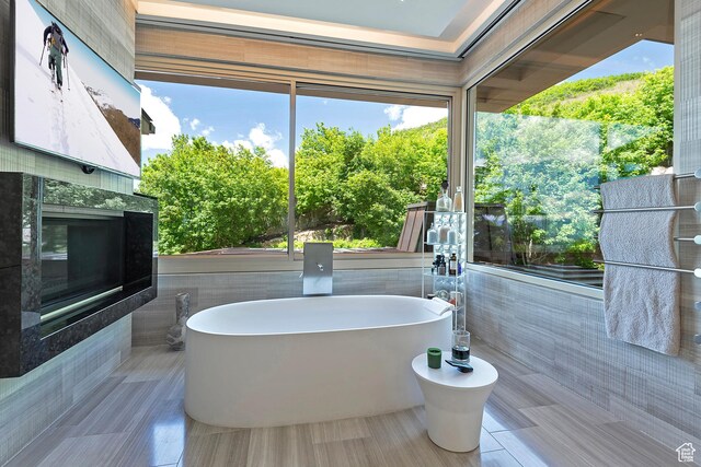 1559 E Tomahawk Dr N, Salt Lake City, UT 84103 - bathroom featuring a tiled fireplace, a washtub, and a bidet
