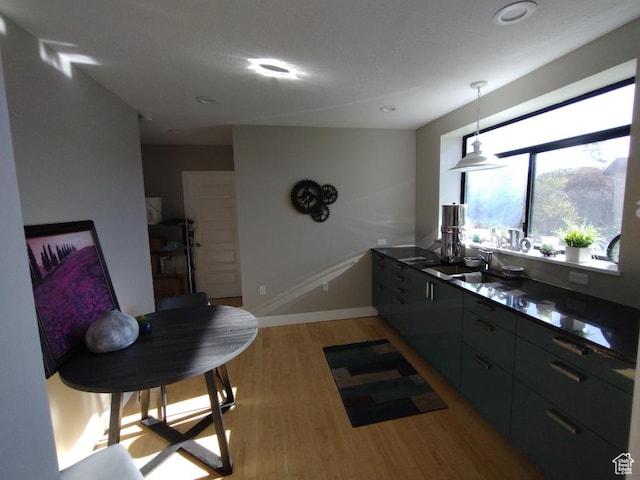 157 W 500 S, Logan, UT 84321 - kitchen featuring light wood-type flooring, pendant lighting, and sink