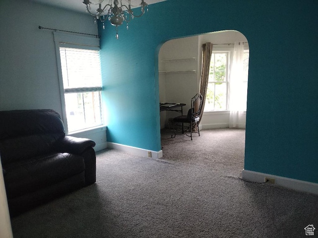 157 W 500 S, Logan, UT 84321 - living area featuring a notable chandelier and carpet flooring