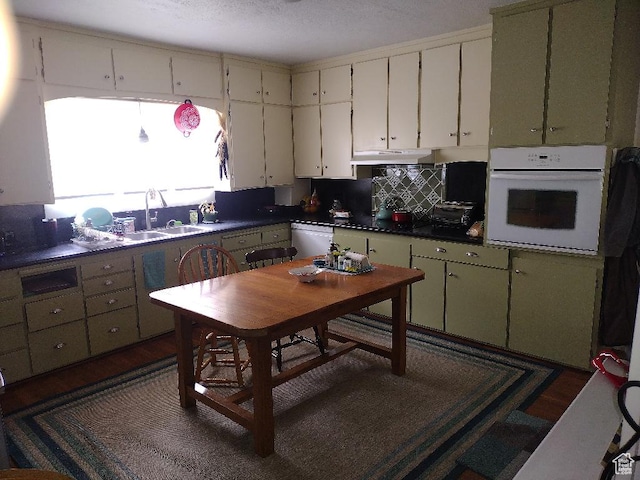 157 W 500 S, Logan, UT 84321 - kitchen with backsplash, sink, white appliances, white cabinetry, and green cabinets