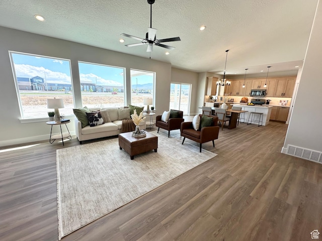 634 E Otto Ln, Grantsville, UT 84029 - living room with wood finished floors, recessed lighting, a healthy amount of sunlight, and visible vents