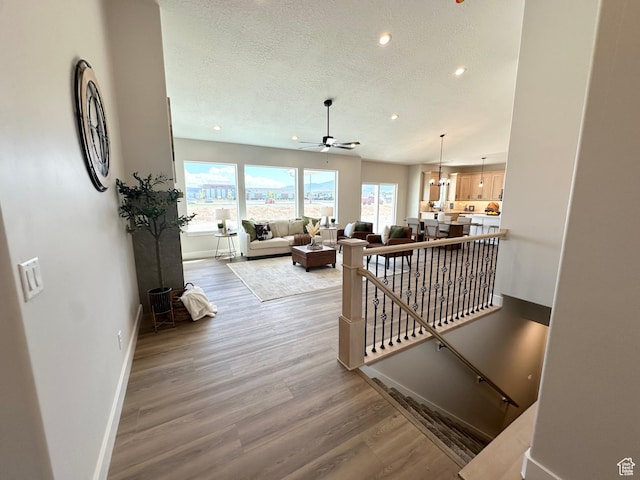 634 E Otto Ln, Grantsville, UT 84029 - hall with baseboards, an upstairs landing, recessed lighting, wood finished floors, and a textured ceiling