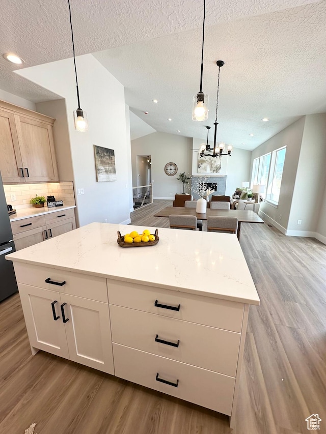 634 E Otto Ln, Grantsville, UT 84029 - kitchen featuring open floor plan, wood finished floors, lofted ceiling, and decorative backsplash